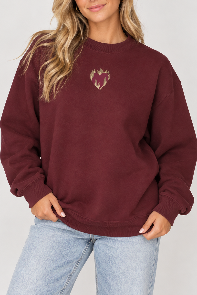 Model wearing the Showgirl Maroon Crewneck with heart and flame design