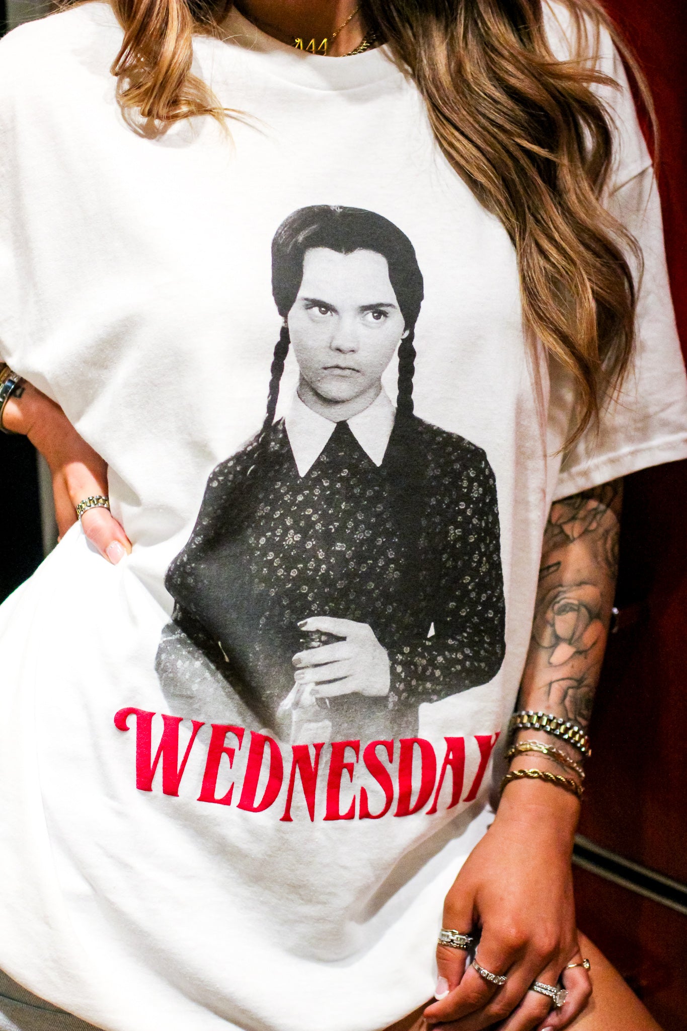 Channel your inner Wednesday with this perfectly pale tee made for lovers of all things dark and deadpan. Printed on a soft, oversized white Comfort Colors tee, this shirt brings spooky season vibes all year long. Pair it with black denim, combat boots, and a stare that could kill.

Whether you're a fan of the Netflix series, the OG Addams Family, or just living your best soft goth life—this tee is your new creepy cute go-to.