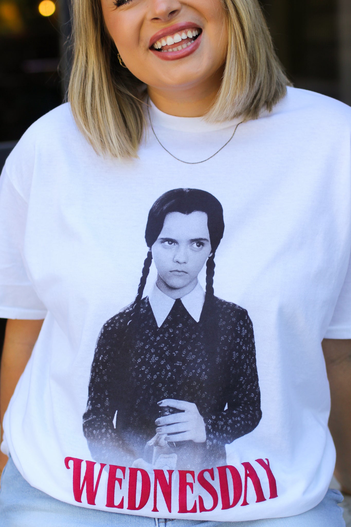 Channel your inner Wednesday with this perfectly pale tee made for lovers of all things dark and deadpan. Printed on a soft, oversized white Comfort Colors tee, this shirt brings spooky season vibes all year long. Pair it with black denim, combat boots, and a stare that could kill.

Whether you're a fan of the Netflix series, the OG Addams Family, or just living your best soft goth life—this tee is your new creepy cute go-to.