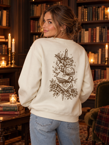 Model wearing the Crowned in Thorns, and Still She Rises Sweatshirt, back view, fae-court romantasy book merch by Girl Tribe Co.