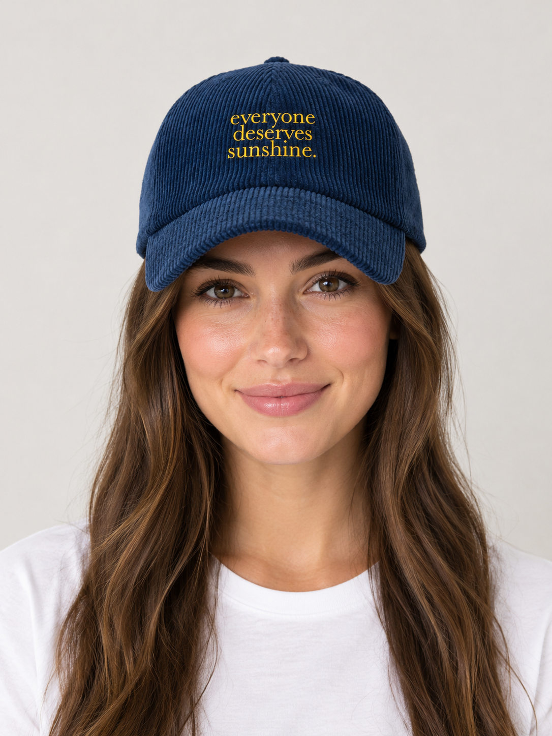 Model wearing the Everyone Deserves Sunshine corduroy hat, rivals-to-lovers hockey romance merch by Girl Tribe Co.