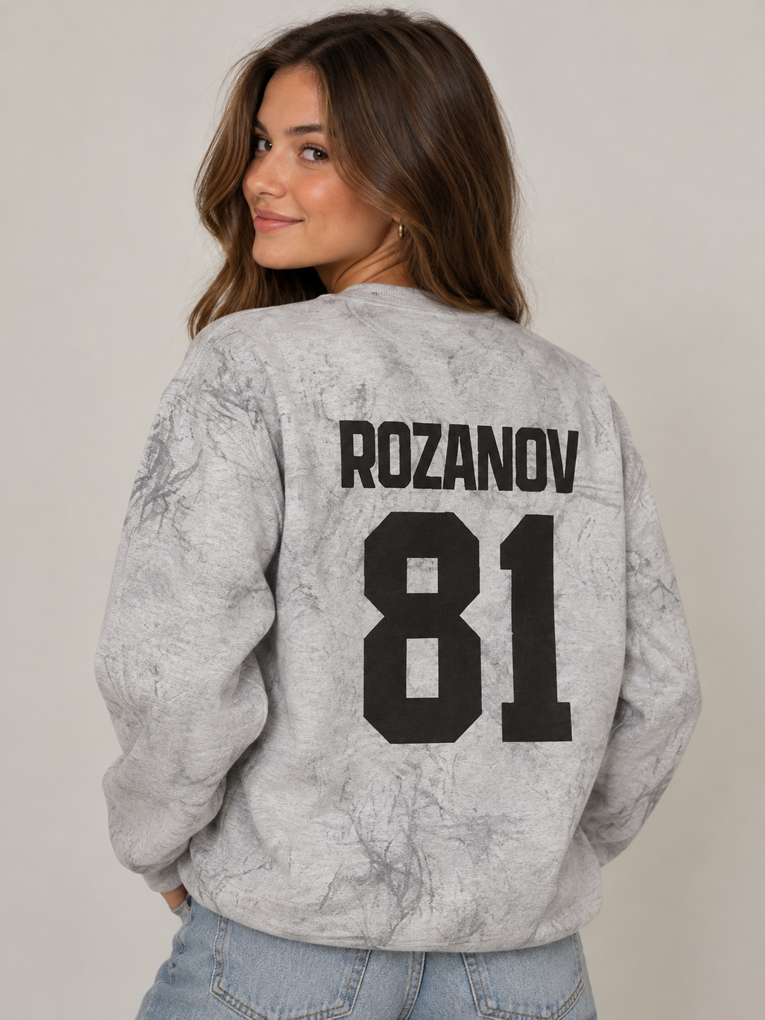 Model wearing the Rozanov 81 Sweatshirt in Smoke Grey, back view, rivals-to-lovers hockey romance merch by Girl Tribe Co.
