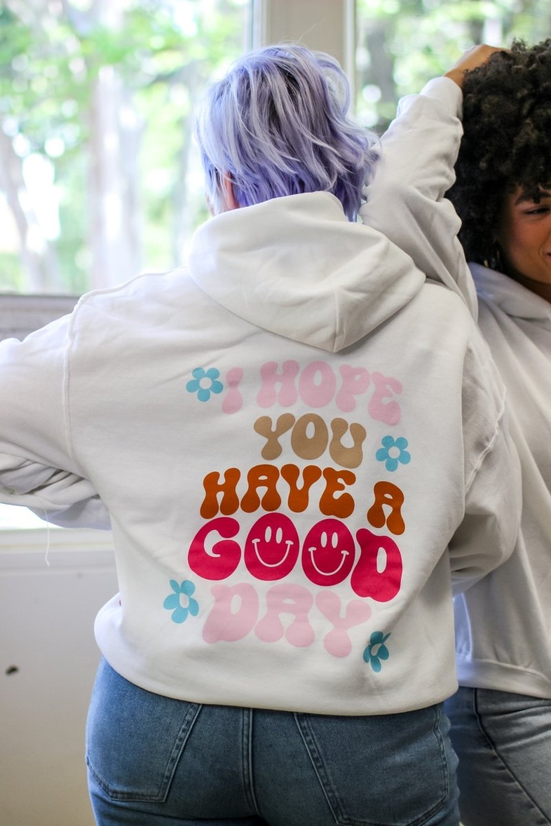 White hoodie with the phrase "I hope you have a good day" in multiple fun colors