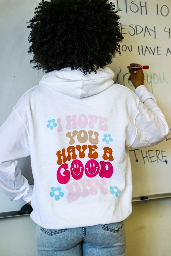 White hoodie with the phrase "I hope you have a good day" in multiple fun colors
