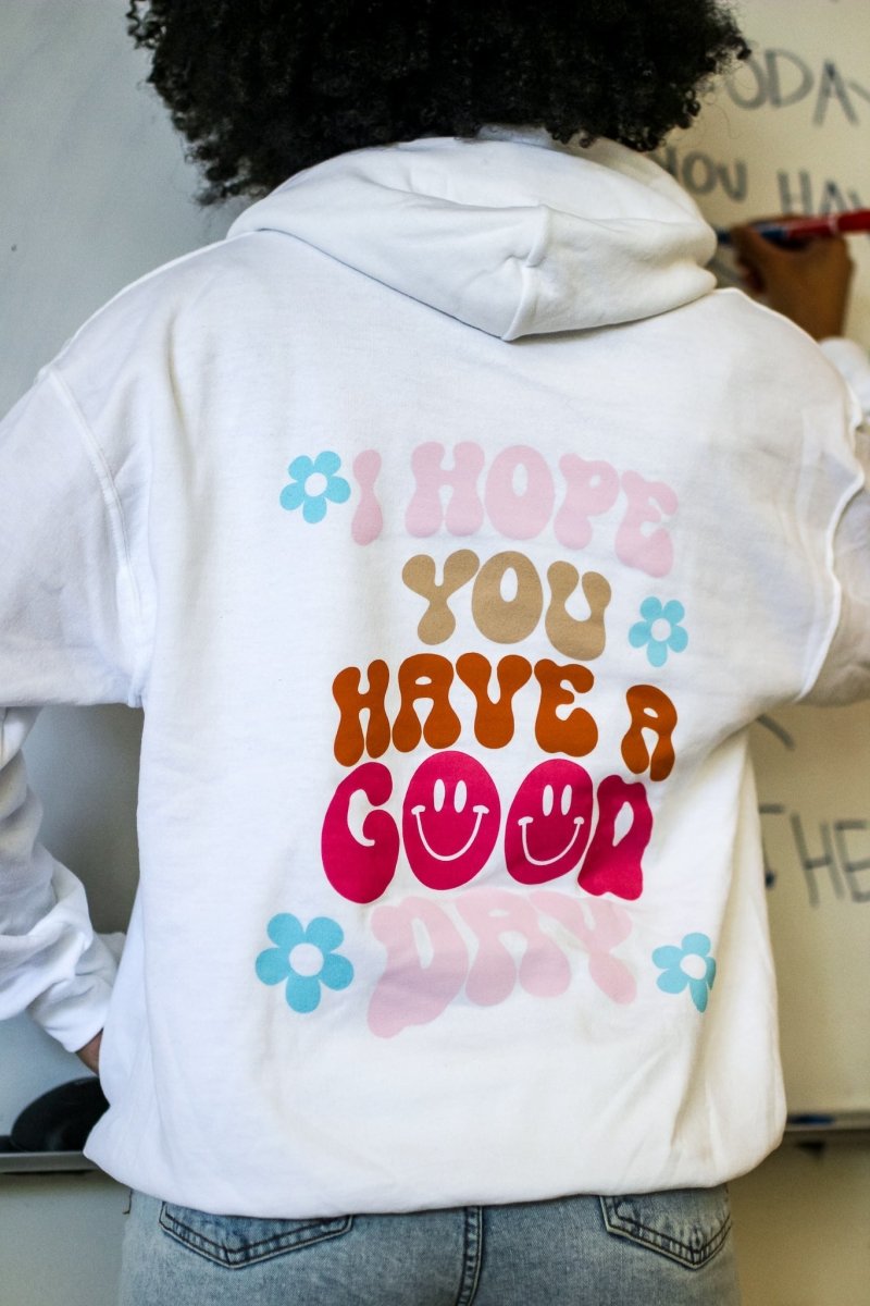 White hoodie with the phrase "I hope you have a good day" in multiple fun colors